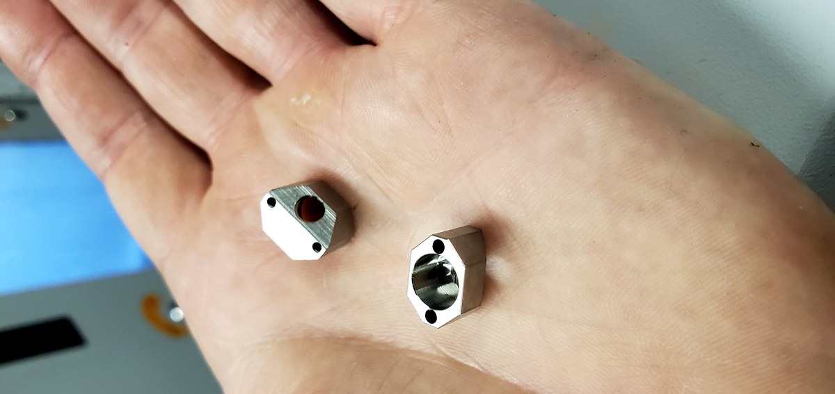 Tiny precision hex parts in palm of hand